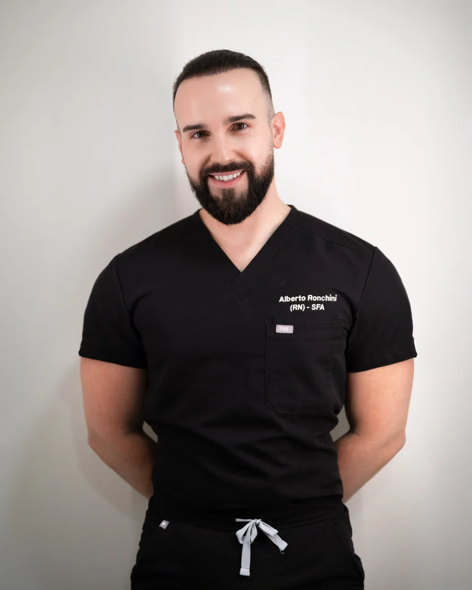 Alberto Ronchini, Advanced Practitioner at SKNCode London Clinic, in black scrubs