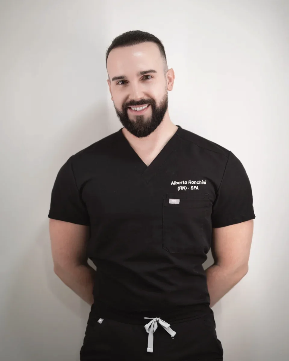 Alberto Ronchini, Advanced Practitioner at SKNCode London Clinic, in black scrubs