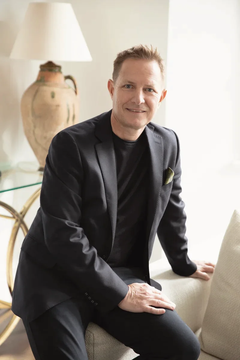 Dr Paul Banwell, Consultant Plastic Surgeon, seated in a consulting room